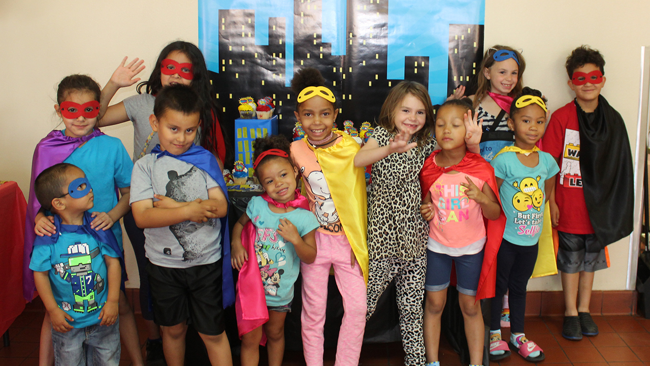 A group of kids dressed in superhero costumes